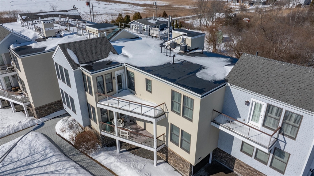 78 Thatcher Road, Unit 6 Gloucester, MA 01930 - Photo 27 of 41 a view of a patio with table and chairs with wooden floor and fence