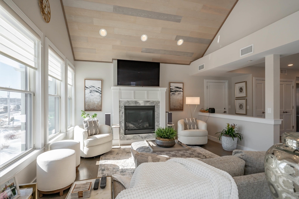 78 Thatcher Road, Unit 6 Gloucester, MA 01930 - Photo 3 of 41 a living room with furniture a fireplace and a flat screen tv