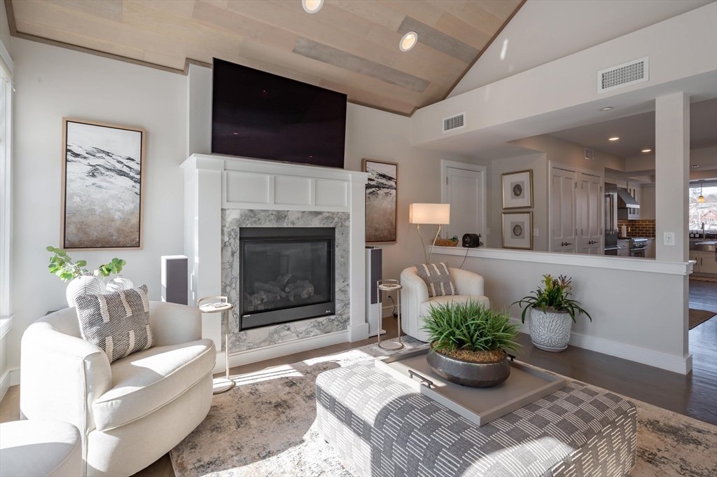 78 Thatcher Road, Unit 6 Gloucester, MA 01930 - Photo 5 of 41 a living room with furniture a fireplace and a flat screen tv
