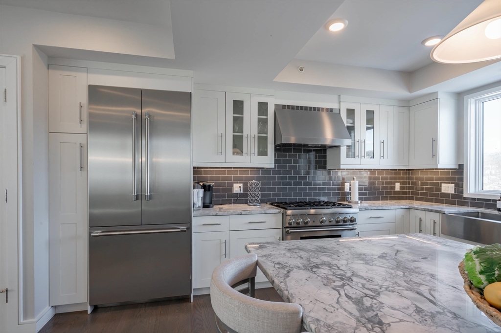 78 Thatcher Road, Unit 6 Gloucester, MA 01930 - Photo 9 of 41 a kitchen with a refrigerator and a stove top oven