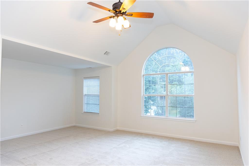 502 Streamside Place Canton, GA 30115 - Photo 18 of 33 an empty room with windows and fan