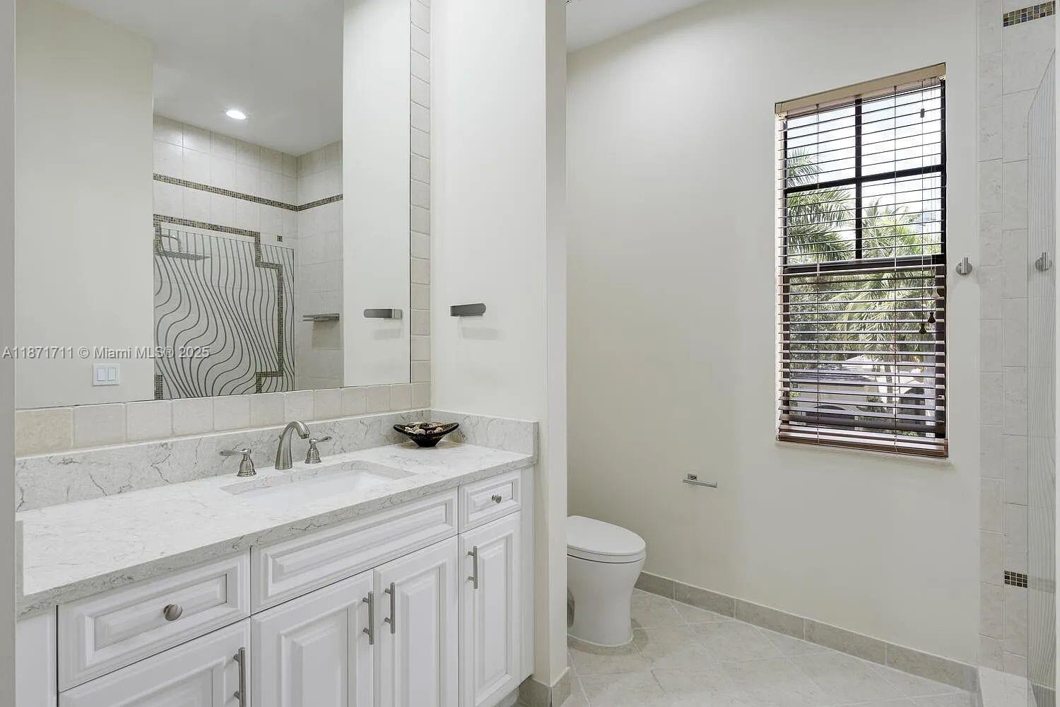 17838 Monte Vista Drive Boca Raton, FL 33496 - Photo 22 of 66 a bathroom with a sink toilet and vanity