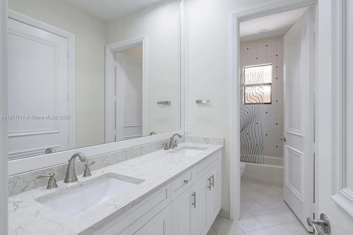 17838 Monte Vista Drive Boca Raton, FL 33496 - Photo 23 of 66 a bathroom with a sink and a mirror