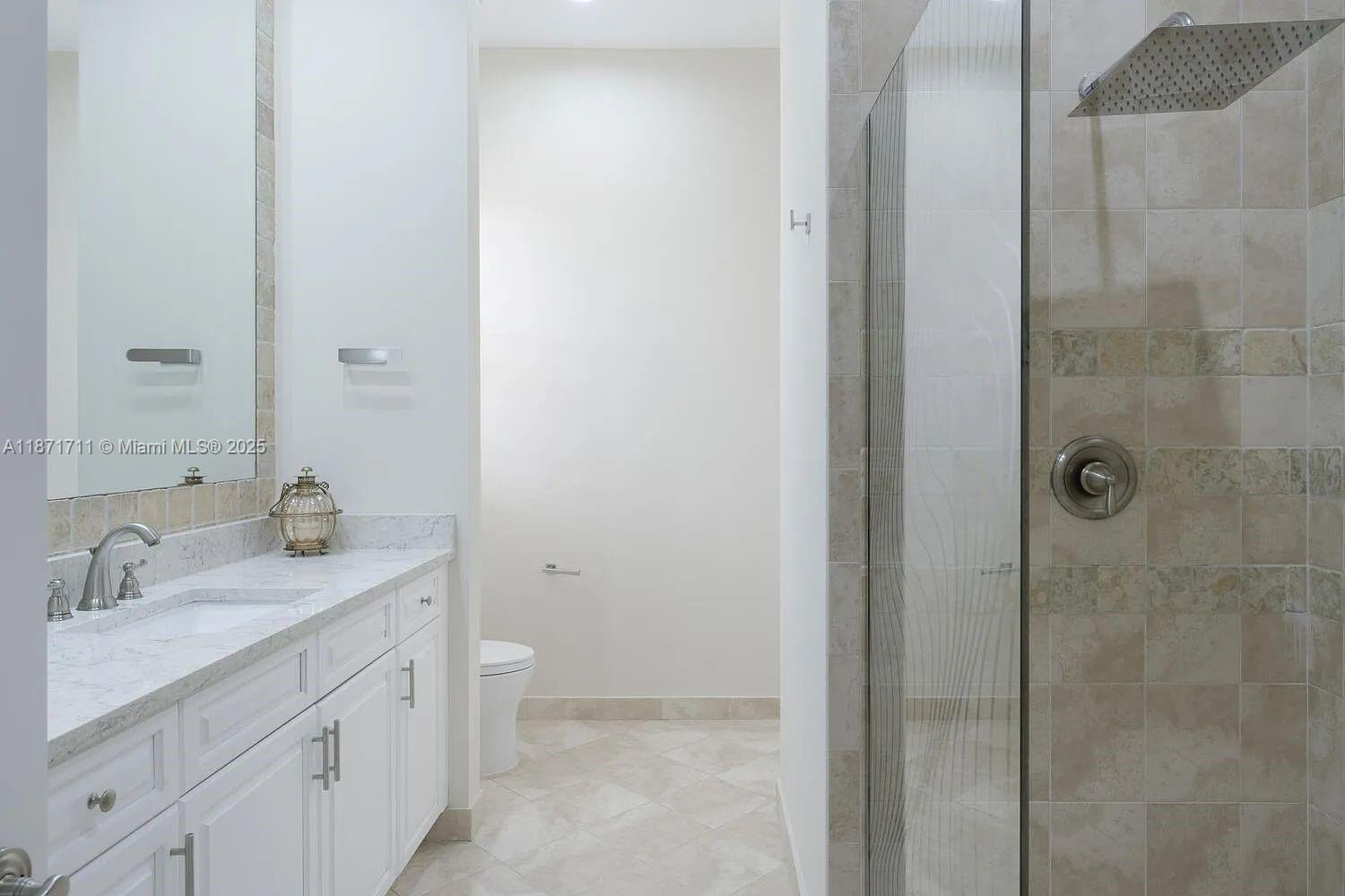 17838 Monte Vista Drive Boca Raton, FL 33496 - Photo 24 of 66 a bathroom with a granite countertop sink a toilet and shower