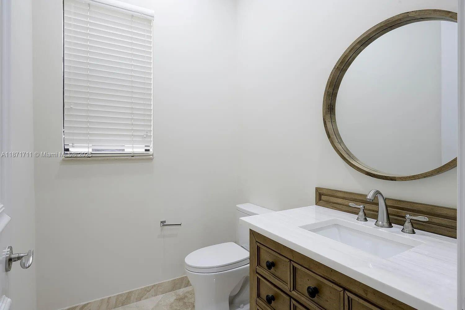 17838 Monte Vista Drive Boca Raton, FL 33496 - Photo 35 of 66 a bathroom with a sink and a mirror