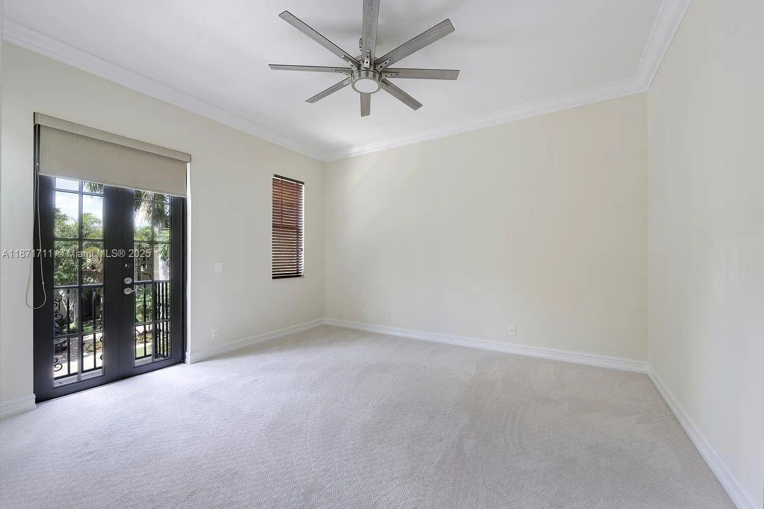 17838 Monte Vista Drive Boca Raton, FL 33496 - Photo 38 of 66 an empty room with a ceiling fan and windows