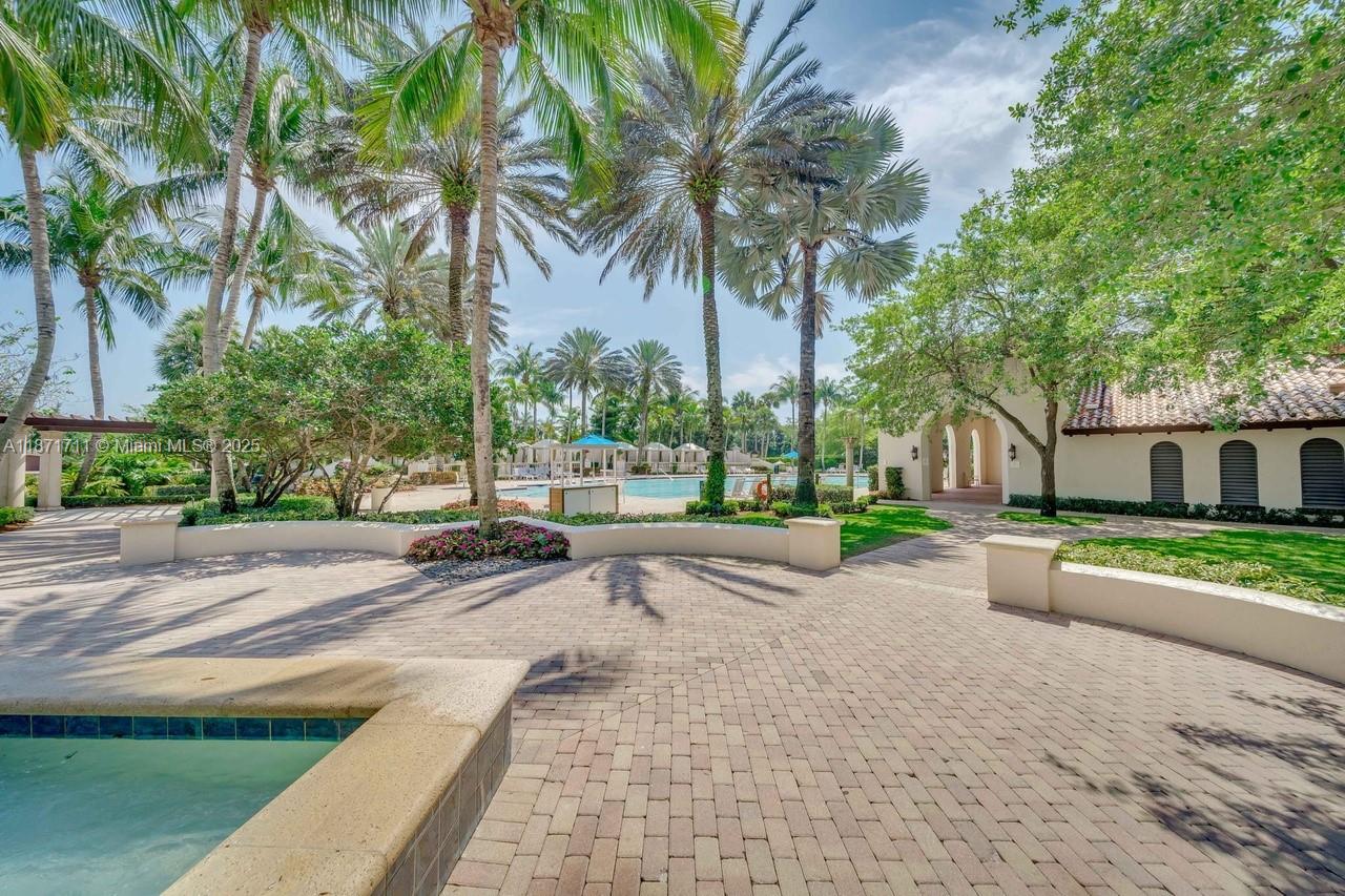 17838 Monte Vista Drive Boca Raton, FL 33496 - Photo 62 of 66 a row of palm trees in front of a house