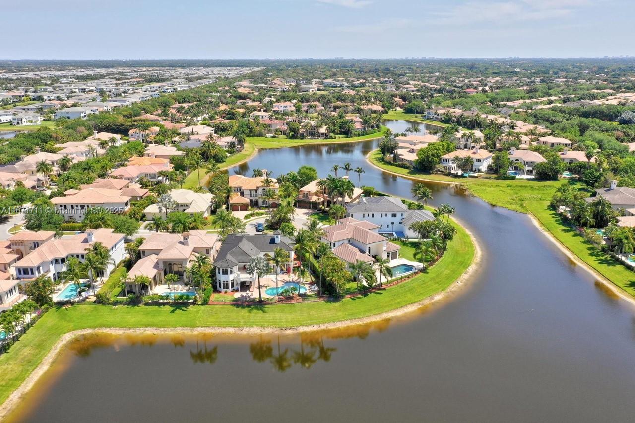 17838 Monte Vista Drive Boca Raton, FL 33496 - Photo 65 of 66 an aerial view of residential houses with outdoor space and lake view in back