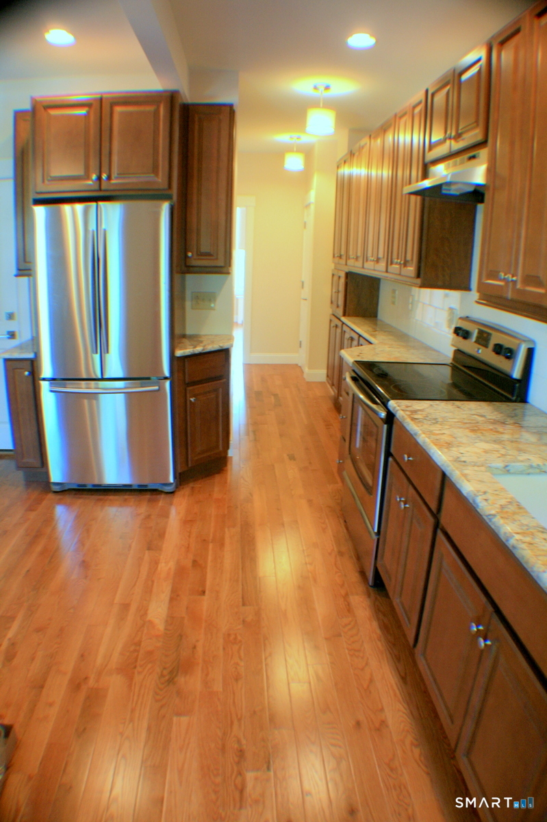 67 Warren Street, Unit 2 New Haven, CT 06511 - Photo 3 of 9 a kitchen with stainless steel appliances a refrigerator and a stove top oven
