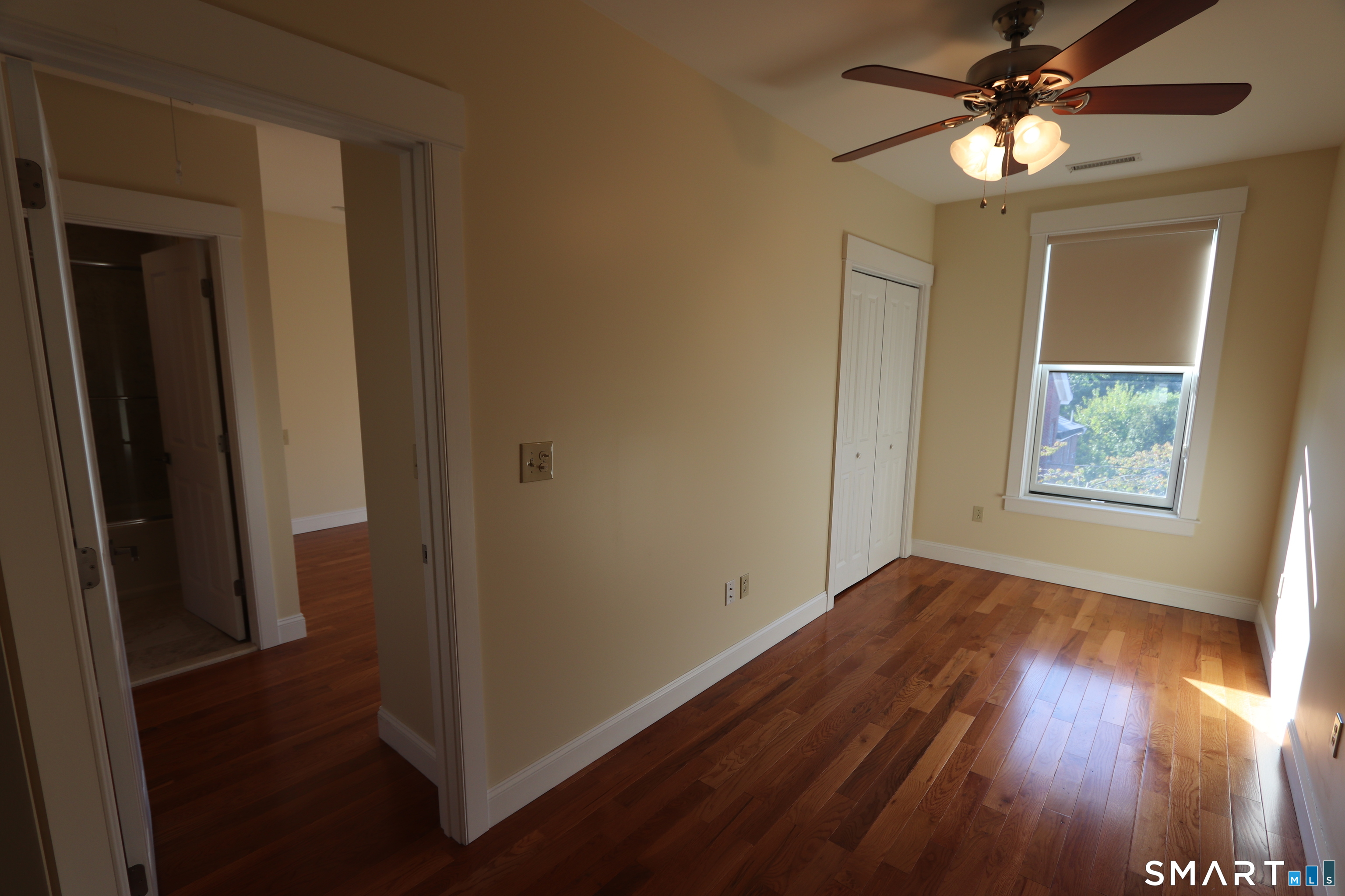 67 Warren Street, Unit 2 New Haven, CT 06511 - Photo 5 of 9 a view of empty room with wooden floor and fan