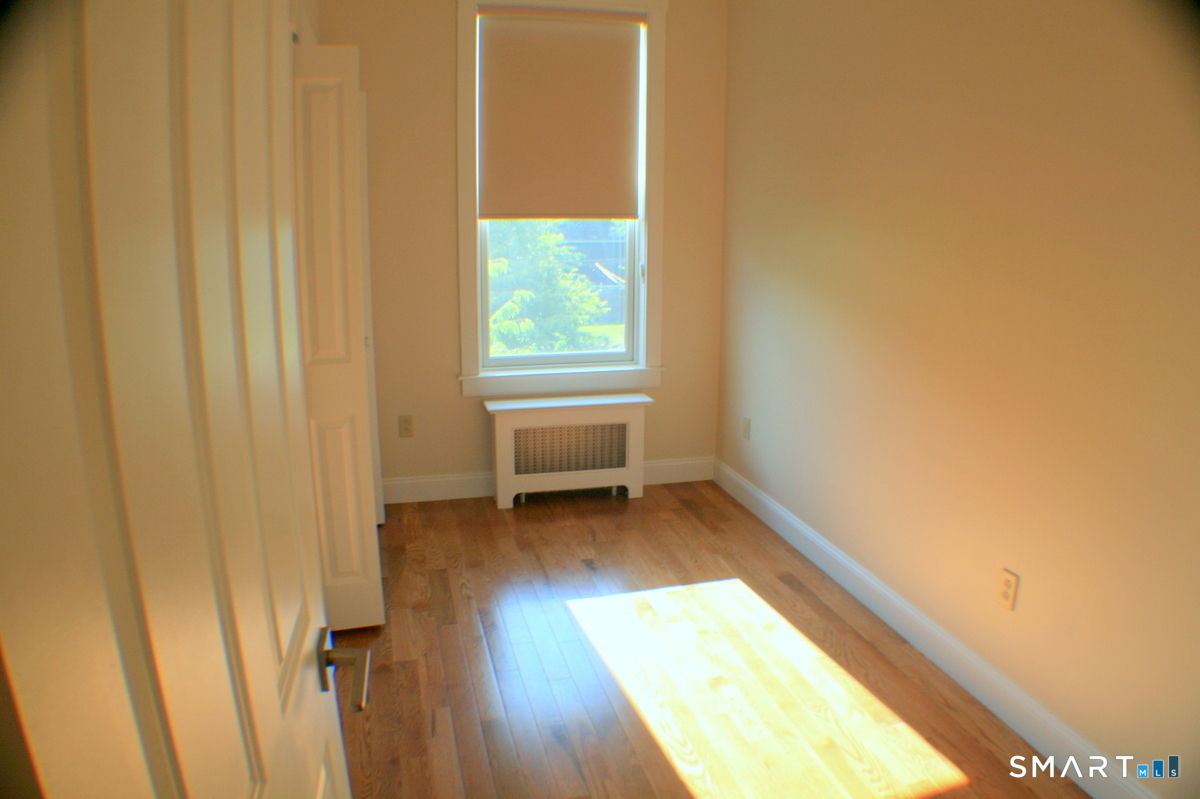 67 Warren Street, Unit 2 New Haven, CT 06511 - Photo 6 of 9 a view of a room with wooden floor and a window