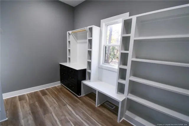 a view of walk in closet with empty racks