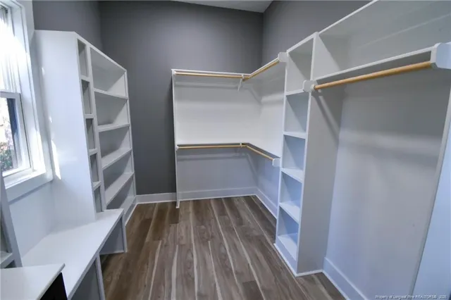 a view of walk in closet with empty racks