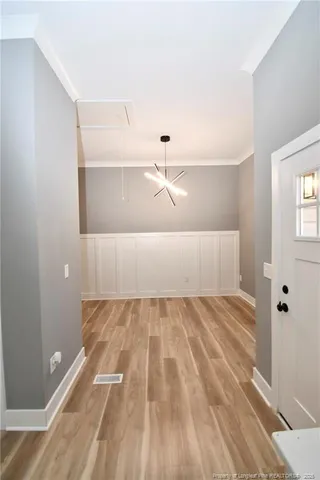 a view of a room with wooden floor