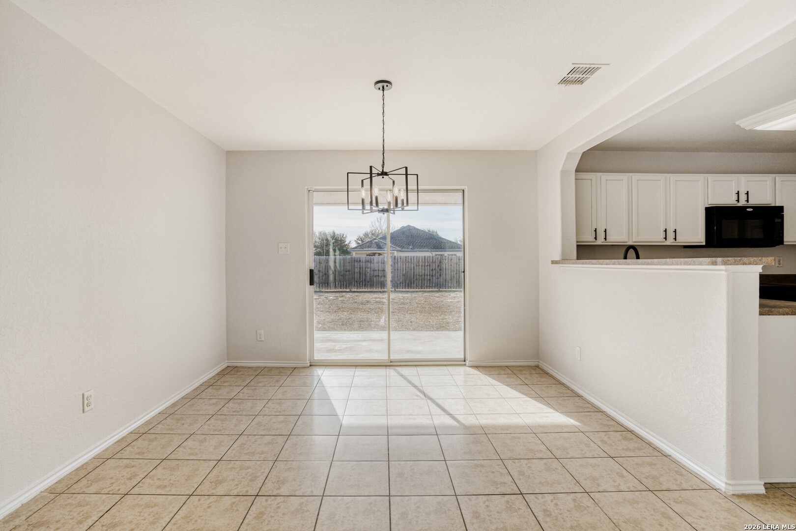 312 Passerina Spur Schertz, TX 78154 - Photo 13 of 26 a view of an empty room with kitchen and window