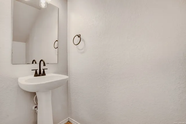 a bathroom with a sink a mirror and shower