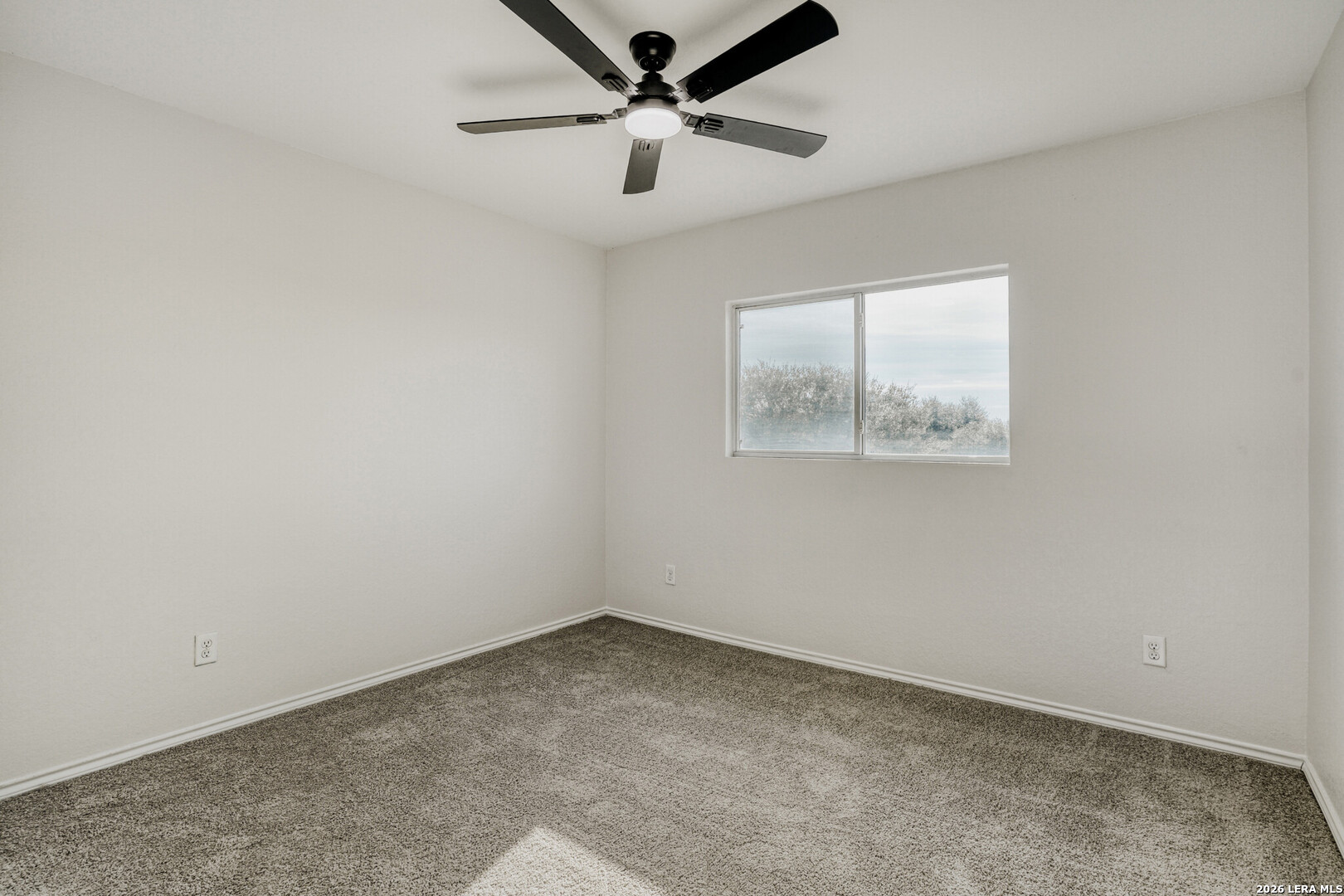 312 Passerina Spur Schertz, TX 78154 - Photo 18 of 26 an empty room with a window and a fan