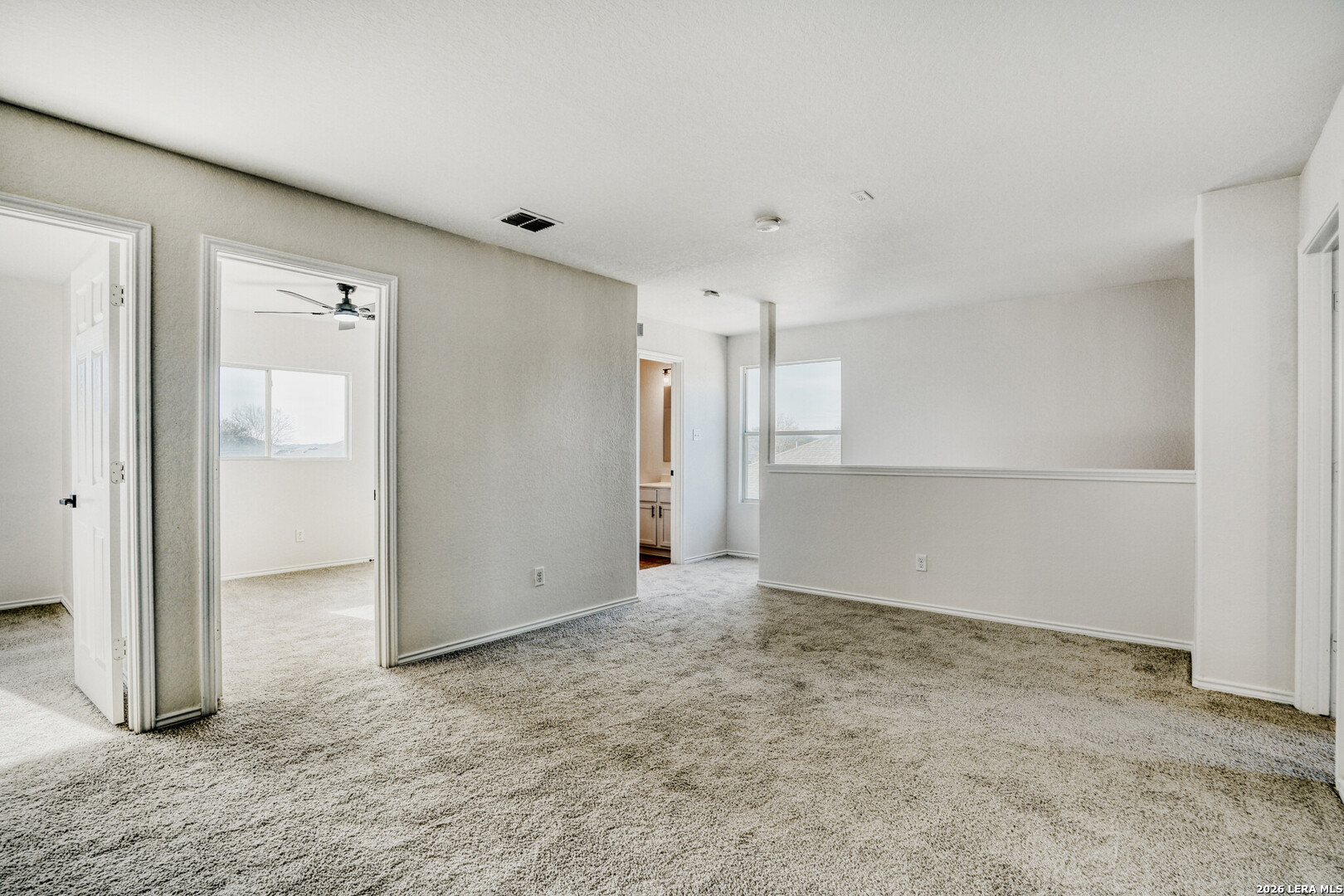 312 Passerina Spur Schertz, TX 78154 - Photo 5 of 26 an empty room with a cabinet and mirrors