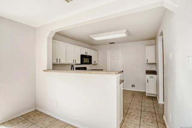 a view of a storage & utility room with cabinets