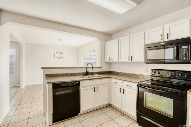 a kitchen with cabinets stainless steel appliances and a sink
