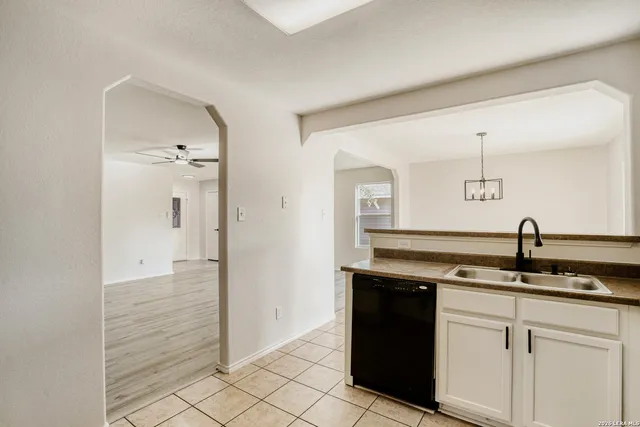 a kitchen with a sink and cabinets