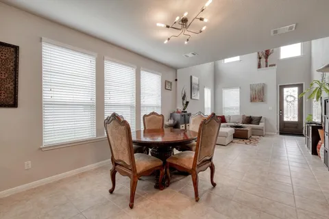 a view of a dining room with furniture and a chandelier