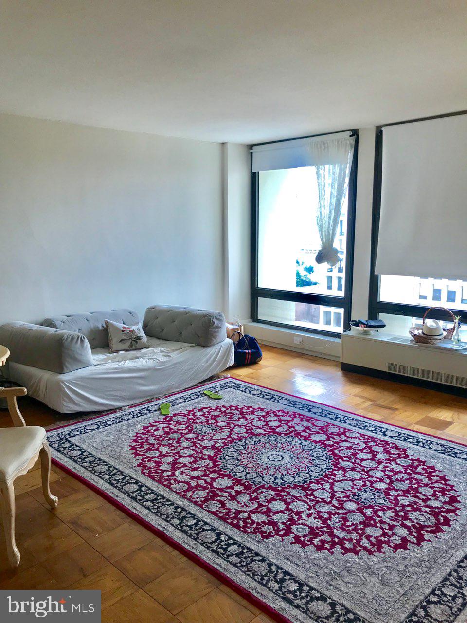 a living room with rug floor and a table