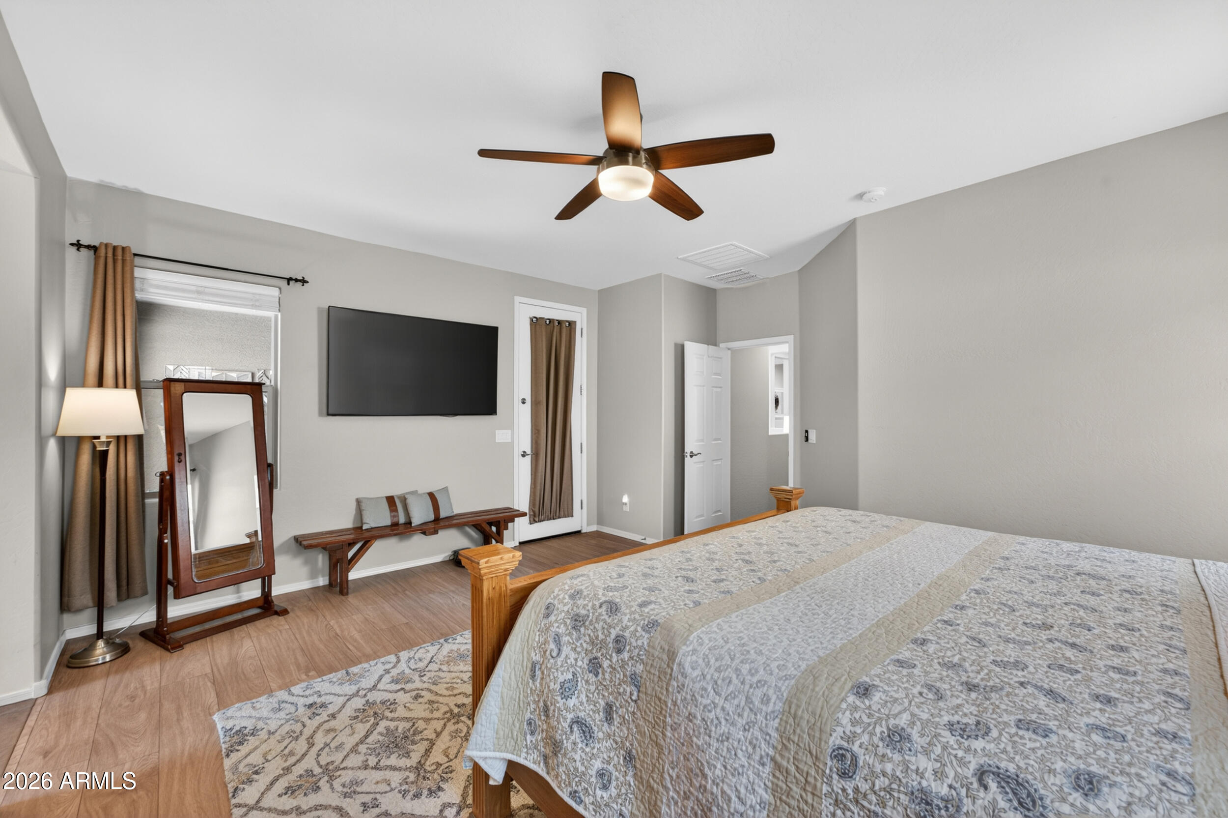 18612 West Mountain View Road Waddell, AZ 85355 - Photo 36 of 71 a spacious bedroom with a bed and a flat screen tv