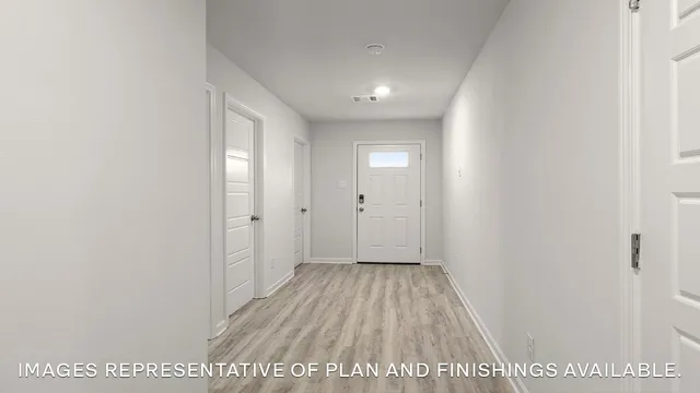 a view of hallway with wooden floor