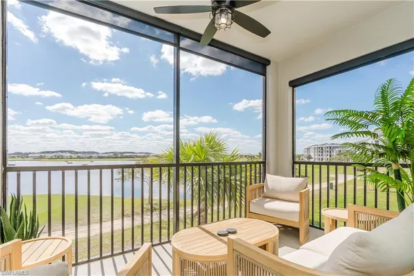 a balcony with furniture and a potted plant