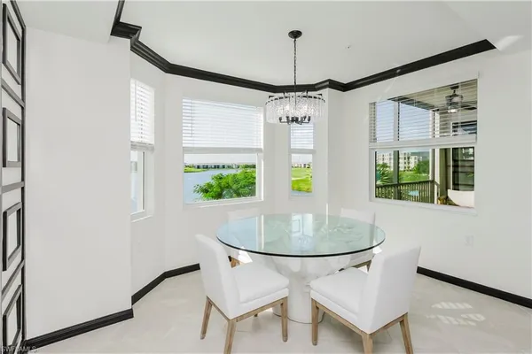 a room with chandelier and windows
