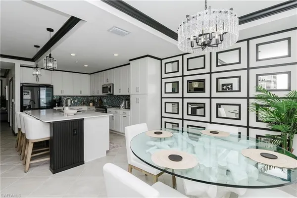 a large kitchen with a table and chairs