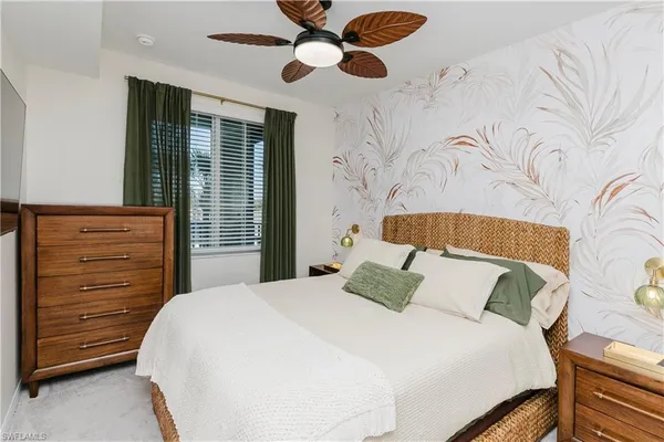 a bedroom with a bed dresser and a window