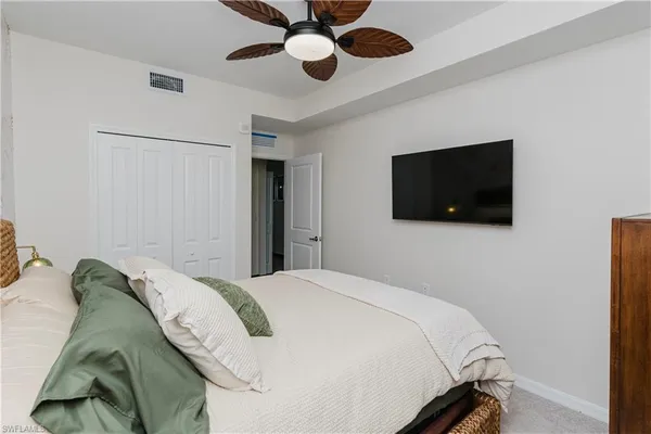 a bedroom with a bed and a flat screen tv