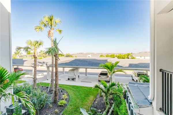 a view of a balcony with a table and chairs
