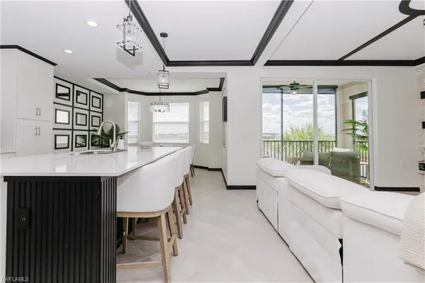 a room with a table chairs and a large window