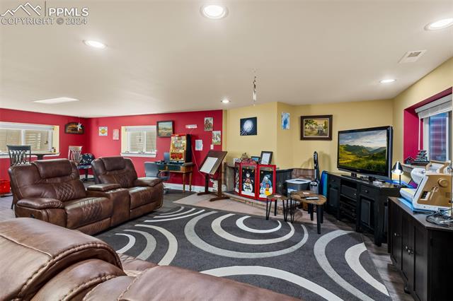 807 Fontmore Road Colorado Springs, CO 80904 - Photo 40 of 50 Living room featuring a healthy amount of sunlight and carpet flooring