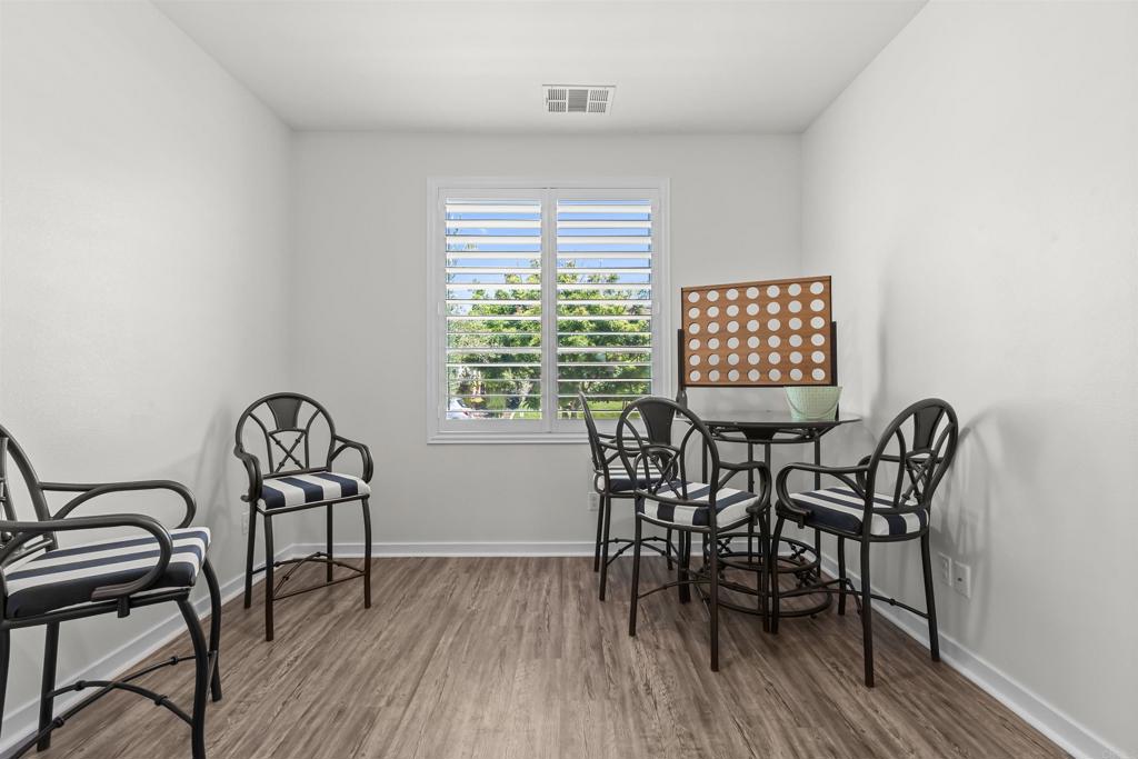 29809 Gypsy Vanner Way Menifee, CA 92584 - Photo 7 of 45 a view of a dining room with furniture and wooden floor