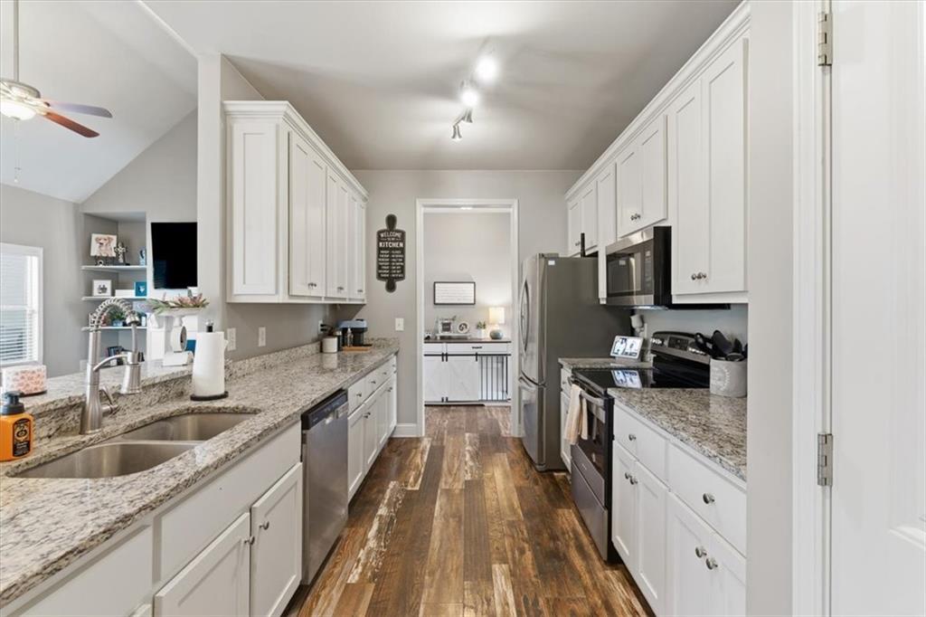 59 Round Rock Circle Northeast Rome, GA 30161 - Photo 11 of 46 a kitchen with stainless steel appliances granite countertop a sink stove microwave and refrigerator