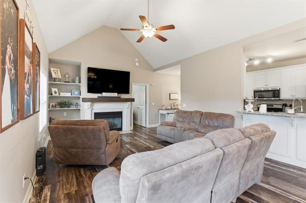 59 Round Rock Circle Northeast Rome, GA 30161 - Photo 18 of 46 a living room with furniture a flat screen tv and a fireplace