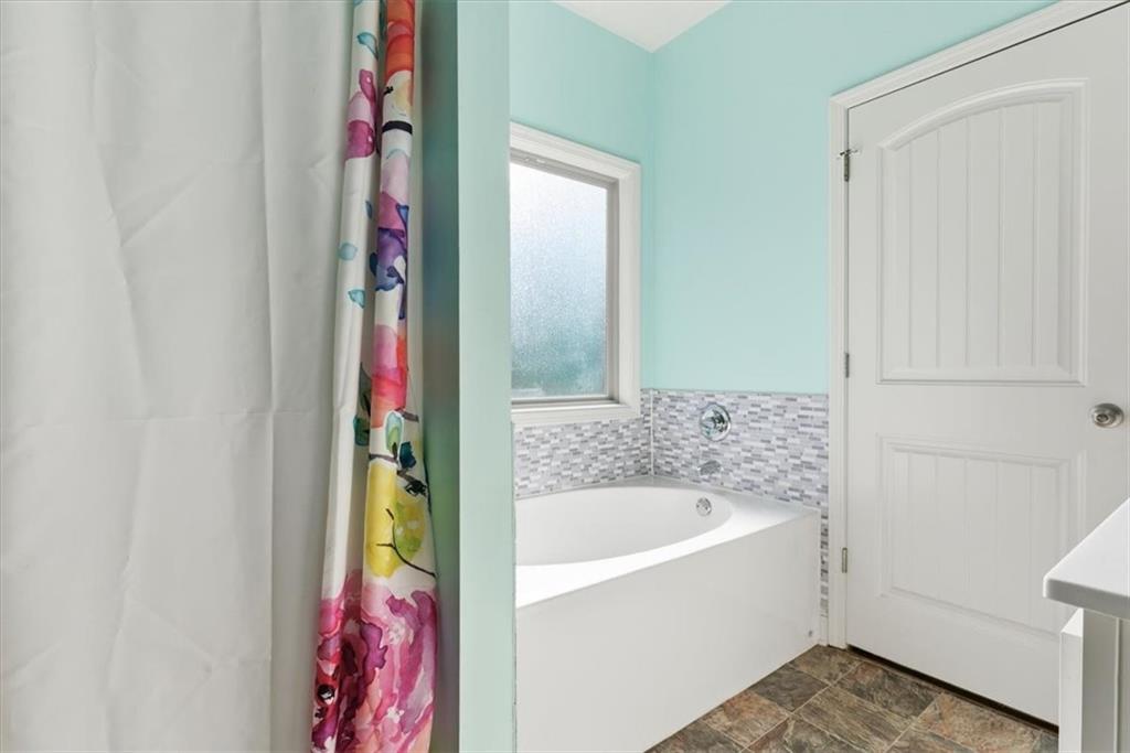 59 Round Rock Circle Northeast Rome, GA 30161 - Photo 24 of 46 a bathroom with a bathtub and a shower
