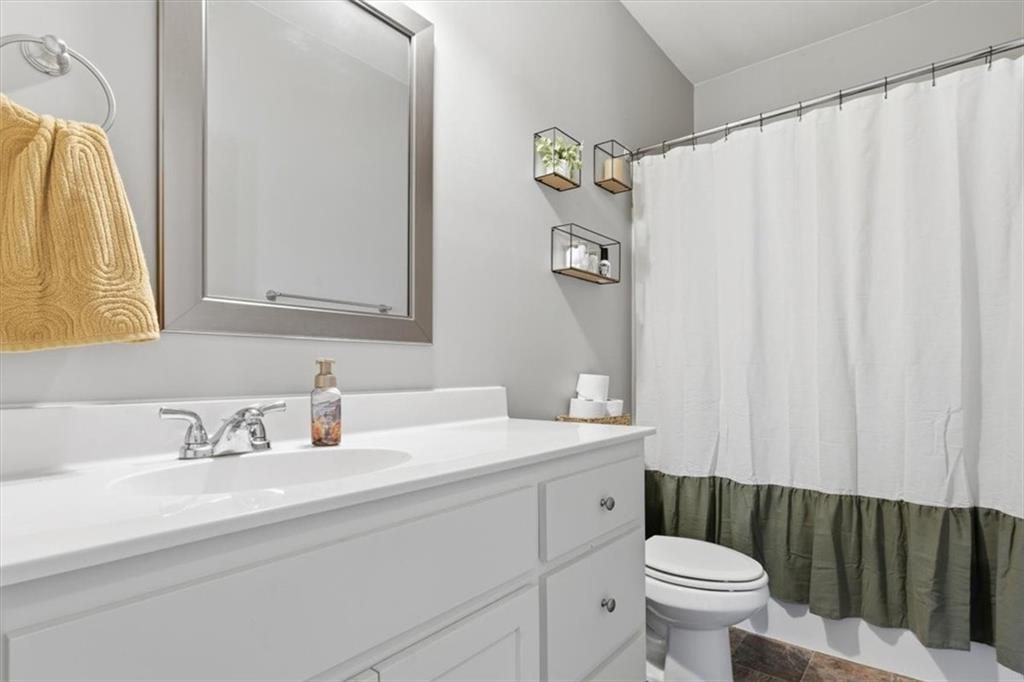 59 Round Rock Circle Northeast Rome, GA 30161 - Photo 28 of 46 a bathroom with a sink a toilet and a mirror