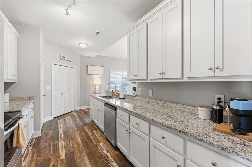 59 Round Rock Circle Northeast Rome, GA 30161 - Photo 8 of 46 a kitchen with granite countertop white cabinets and white appliances