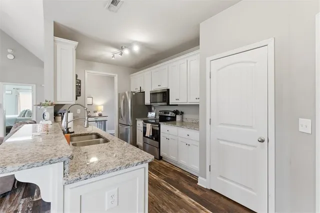 a kitchen with a refrigerator and cabinets