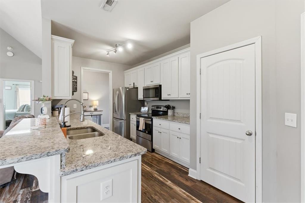 59 Round Rock Circle Northeast Rome, GA 30161 - Photo 9 of 46 a kitchen with granite countertop a refrigerator stove and sink