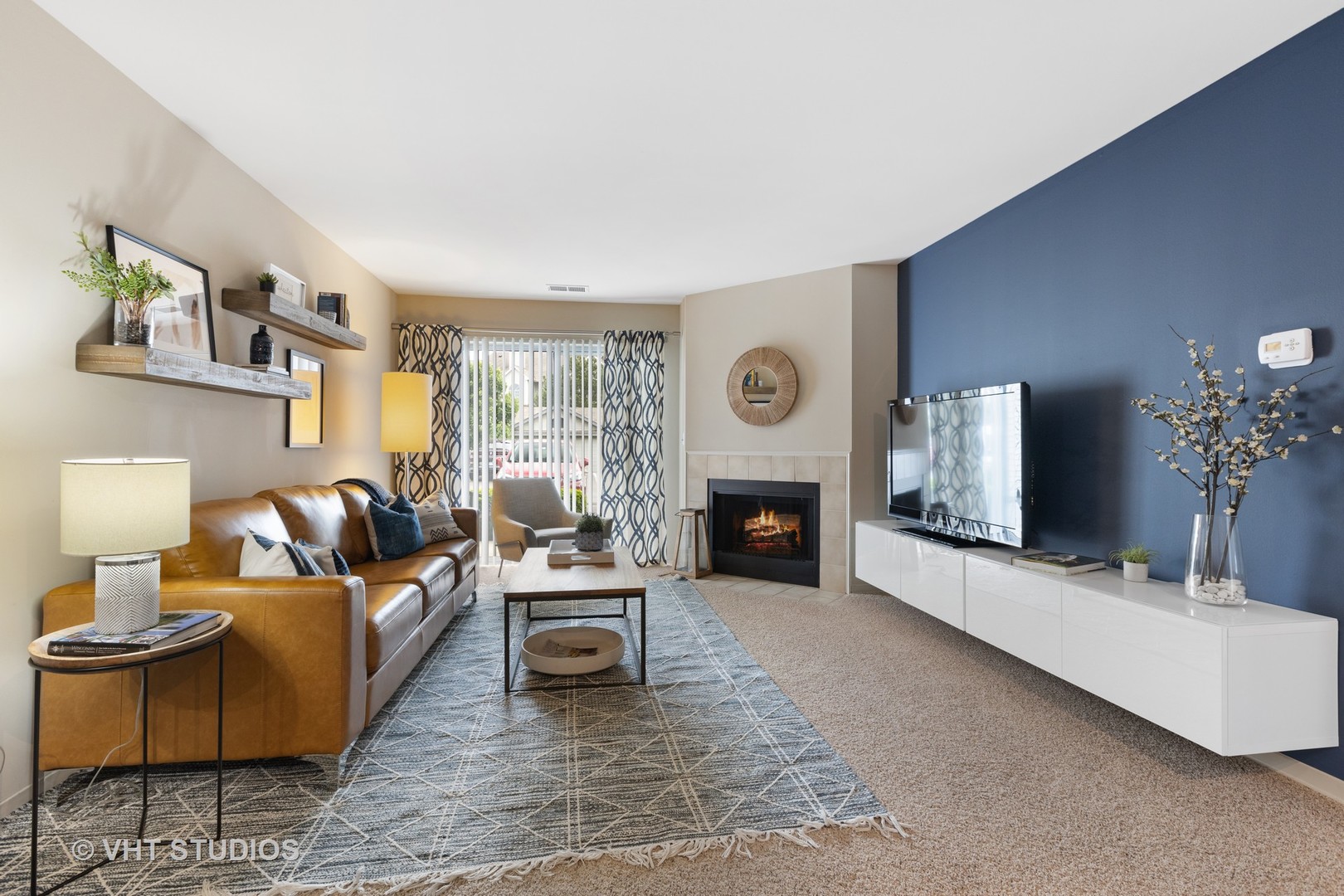 26 Sterling Circle, Unit 108 Wheaton, IL 60189 - Photo 7 of 40 a living room with furniture a fireplace and a potted plant
