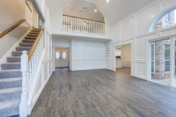 a view of an entryway with wooden floor and stairs