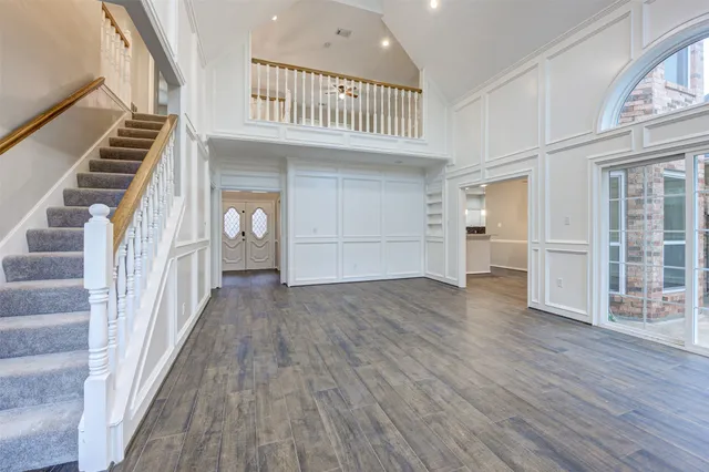 a view of a room with wooden floor and a window