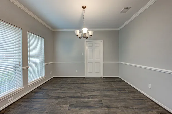 a view of a room with wooden floor and a window