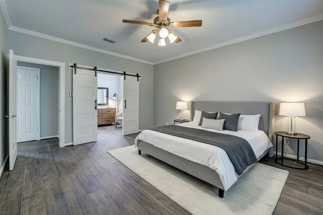 a bathroom with a granite countertop sink a toilet and shower